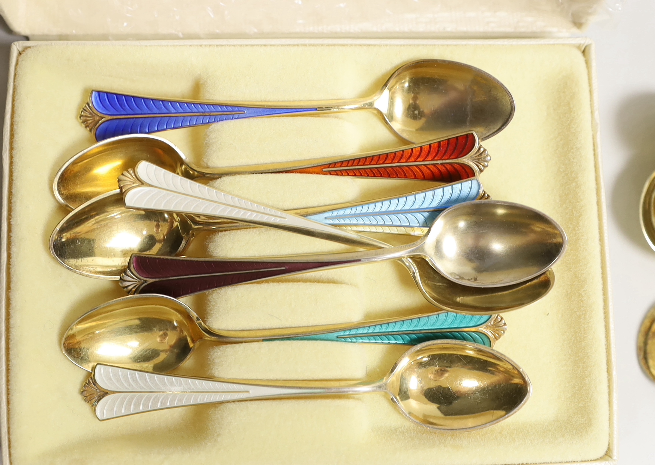 Two sets of eight Norwegian 925S and polychrome enamelled coffee spoons, by David Andersen, one other cased set of six Norwegian 925 and enamelled coffee spoons, a similar spoon and fork, a set of twelve Danish sterling